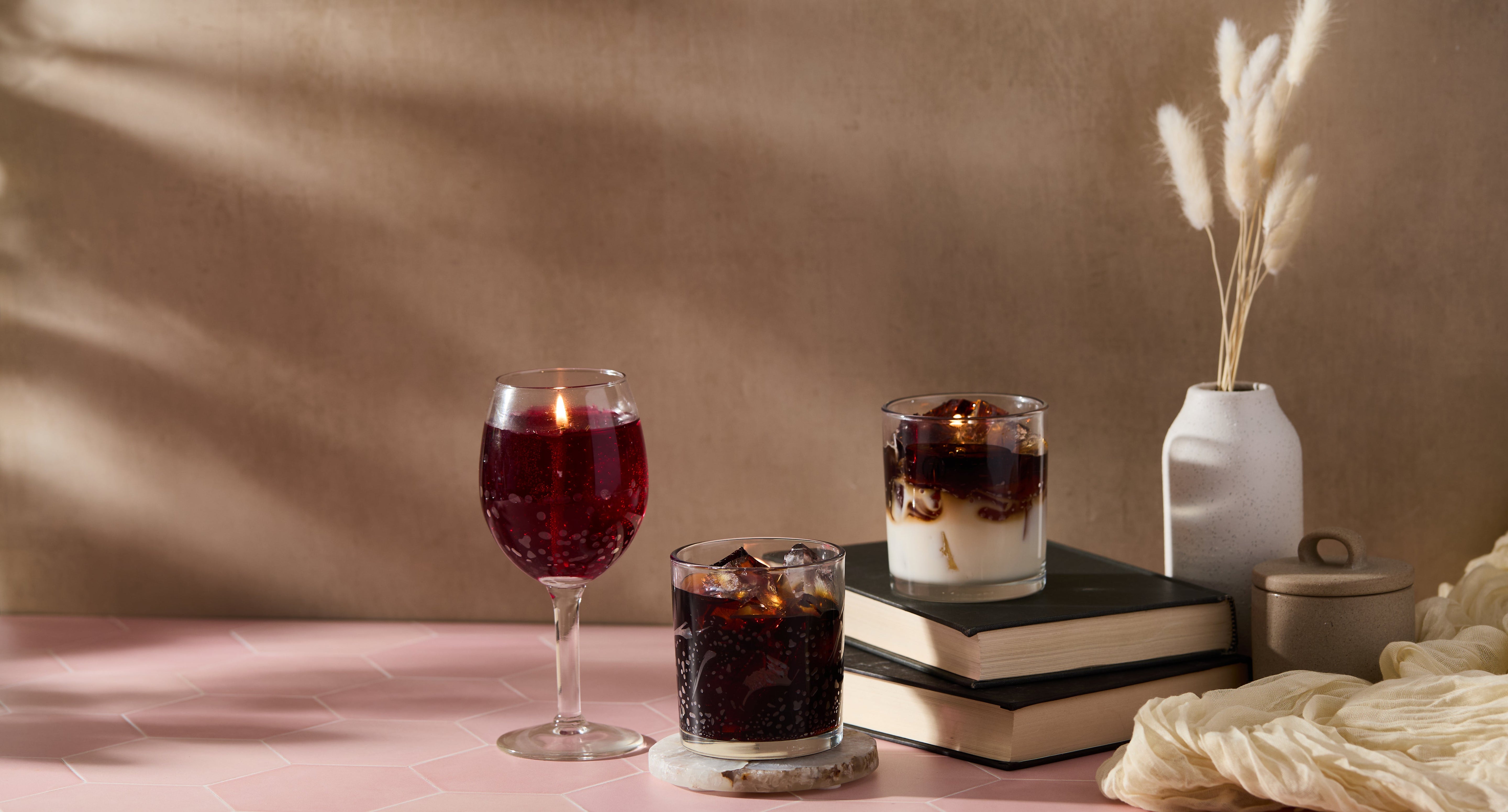 Close-up of clear gel wax chunks in a gray concrete bowl on a neutral surface, showcasing their translucent texture and glossy finish.