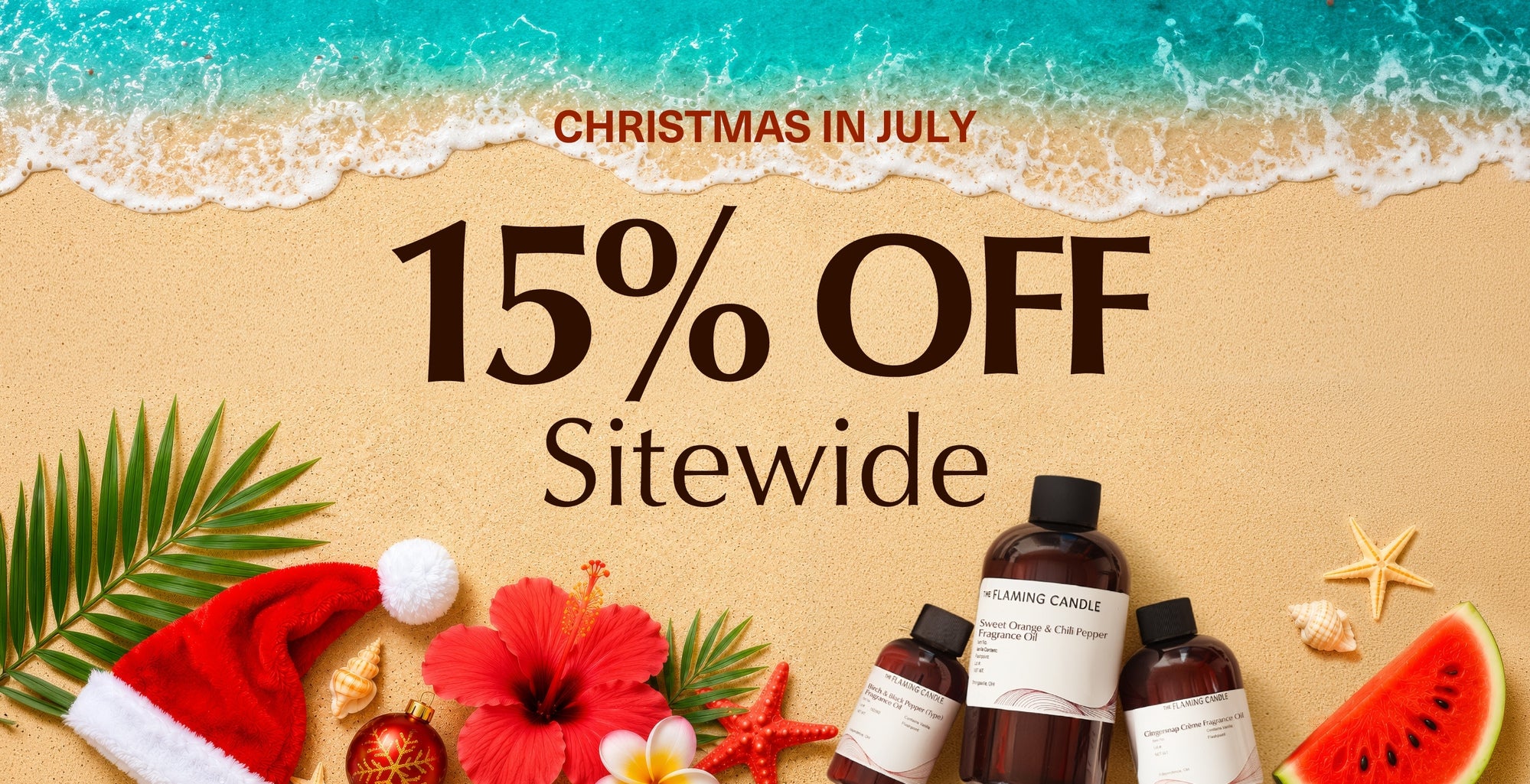 Christmas in July sale banner on a sandy beach with ocean waves, palm leaves, a Santa hat, hibiscus flower, ornaments, fragrance oil bottles, seashells, starfish, watermelon, and the text: “CHRISTMAS IN JULY 15% OFF Sitewide.”