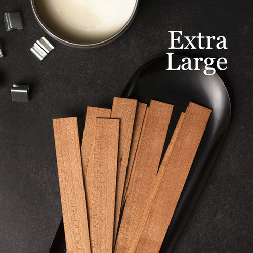 Wooden strips on a black plate with 'Extra Large' text and metallic objects on a dark background