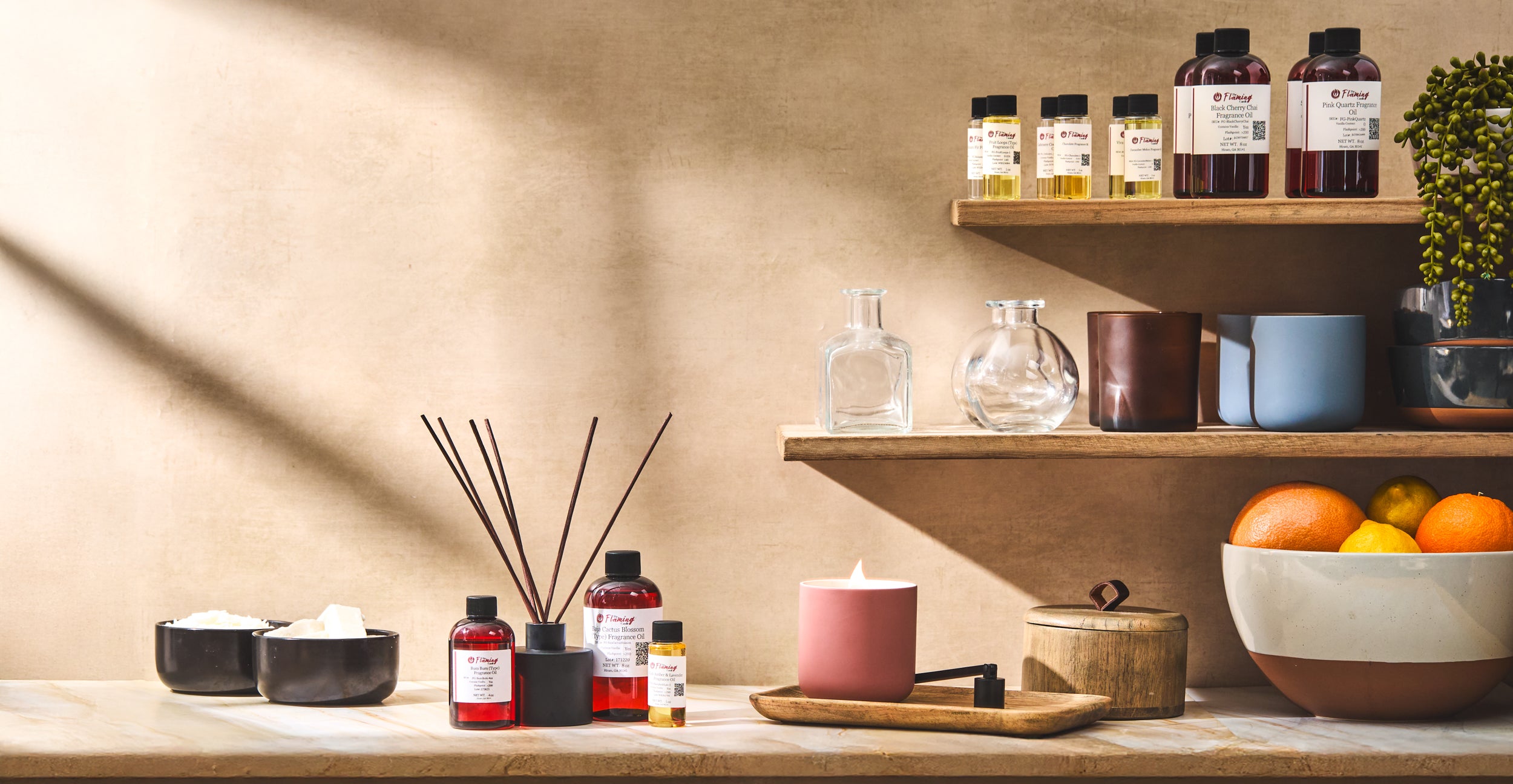 Shelf with various bottles, a candle, and decorative items against a beige wall.